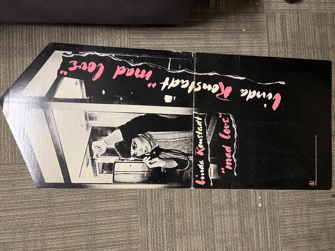 Linda Ronstadt â€œ Mad Love â€œ 1980 Elektra / Asylum Records Easel Display: Linda Ronstadt â€œ Mad Love â€œ 1980 Elektra / Asylum Records Easel DisplayThis display is missing part of the easel on the back. The front has some creasing and edgewear. Corner damage as wel