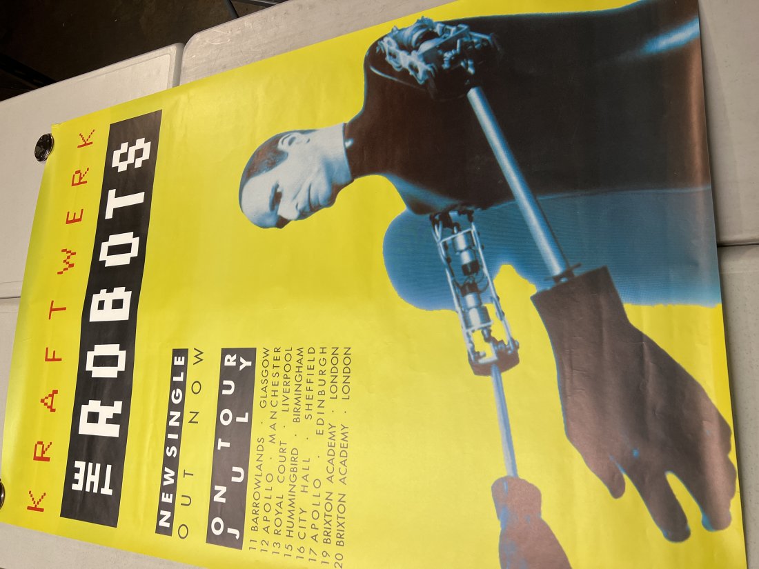 Kraftwerk The Robots UK Tour Promo Poster: Poster may show minimal damages such as cornerwear, edgewear as shown in photos. Posters may also show crease marks due to prior forms of storage. Measurements: 60” x 40”