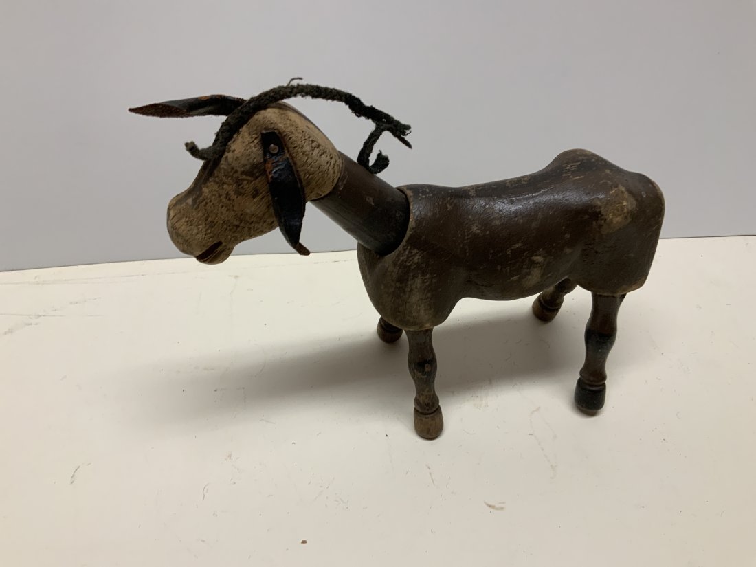 Antique folk art wooden jointed donkey toy: Early toy. Jointed farm animal. Leather ears. 7 inches tall. 8 inches long. Please examine photos carefully in order to determine the condition of the item. Photos are ultimately the best indication o