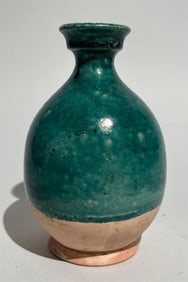 Tang Dynasty Peacock Blue Glazed Pan Mouth Bottle