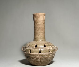 Primitive celadon hollowed out pitcher