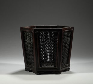 In the Qing Dynasty, the rosewood hexagonal hollow pen holder