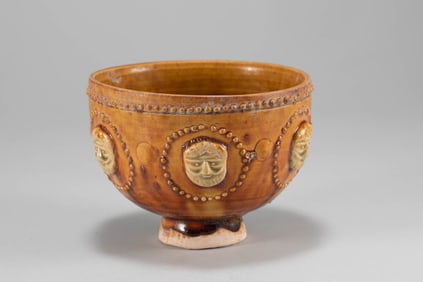 Tang Dynasty yellow glazed bowl with human face shape