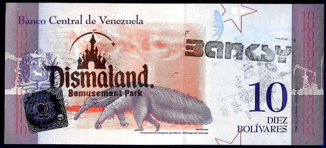 Banksy - Banknote 10 Bolivares with artist's stamp Dismaland 2015 in Acrylblock Frame - 2