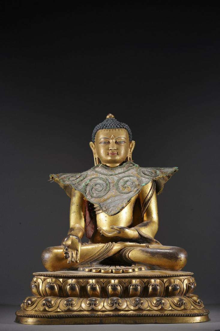 A GILT-BRONZE FIGURE OF SAKYAMUNI, MING DYNASTY (1 of 9)