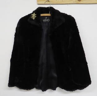 Ladies Black Mink Stole Jacket Weber's Zanesville OH: Black mink / fur stole jacket sleeveless w/side pocket cutouts to insert hands for warmth, 29" overall label for Weber's of Zanesville, OH. Orig Costume Jewelry Pin attached to the collar.