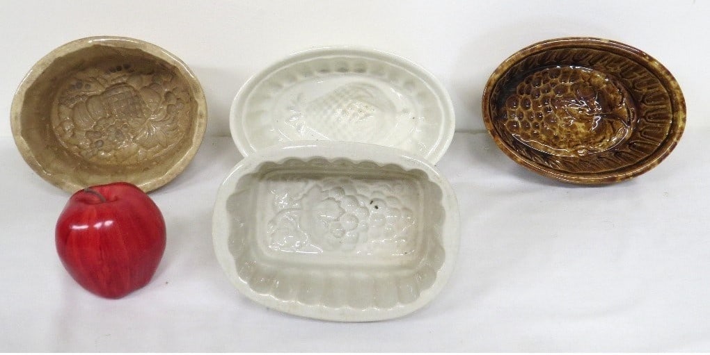 Lot of 4 Early Yelloware Molds Various Fruits: A nice group of 4 yelloware molds c. late 19th C / early 20th, one in a Rockingham or Bennington glaze. Motifs include a Cornucopia basket, pineapple and grapes. Good overall condition