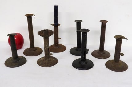 A Group of Early Hog Scraper Iron Candlesticks