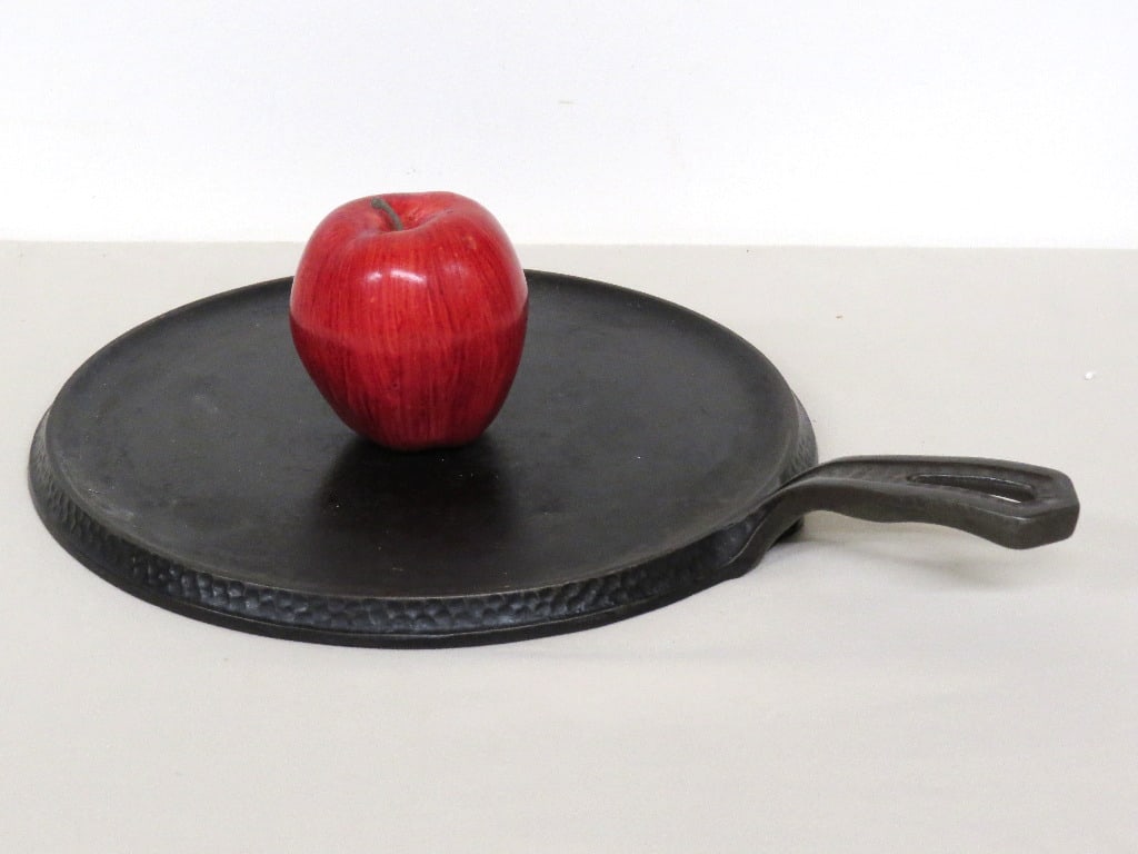 An Erie Griswold No. 2039 No. 9 Hammered Iron Skillet: An interesting Arts & Crafts era Griswold skillet with hammered or peened iron decorative work around base & on handle, Marked No. 2039 and is No. 9 sized.