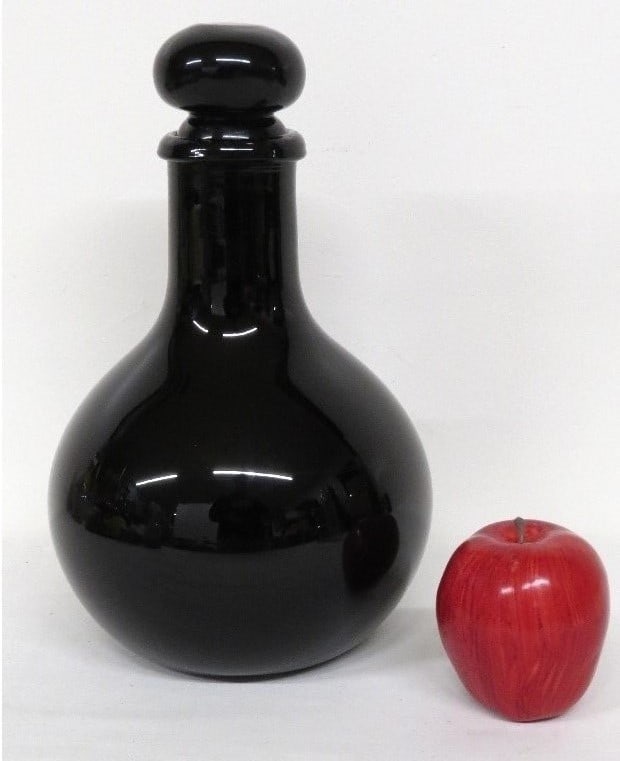 A 19th C. French Deep Amethyst Decanter or Apothecary Jar: A globular form wide mouth blown decanter with ground pontil that appears black but is a deep amethyst color. Stands 12" to top of stopper, European, possibly French, with ground stopper and lots of w