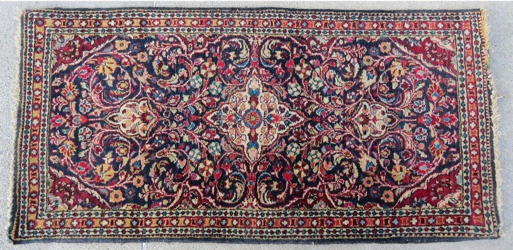 A busily detailed Persian Sarouk Purples, Reds, Blues: Believed to be a Persian Sarouk, antique, busily decorated in purples, reds & blues among other colors. Hand knotted/tied, measures 50" by 25" in size.