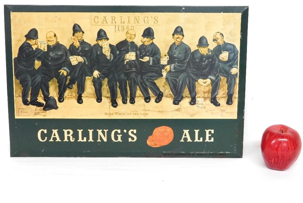Vintage Carling's Ale "Nine Pints Of The Law" Tin Sign: An original Carling's Ale beer advertising sign, measuring 19" x 12" in size. Titled, Nine Pints Of The Law picturing 9 police officers enjoying a pint. Litho by Lawson Wood (1878-1957), a famous comm