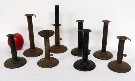 A Group of Early Hog Scraper Iron Candlesticks