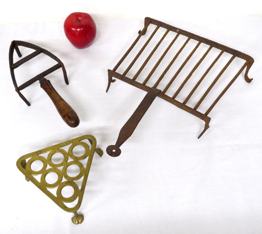 Three 19th C. Fireplace Trivets in Brass & Wrought Iron: Three 19th C. trivets in brass and wrought iron, first being an exceptionally early and crude blacksmith wrought rectangular trivet being 11" wide and 15" including handle, the second a small tri-foot