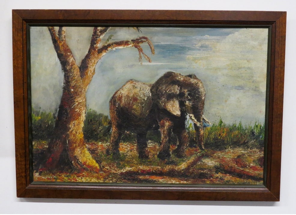 A Signed O/C of an African Elephant: An oil on canvas of an African elephant with tusks underneath the shade of a tree, it is signed lower RH corner, starts with Mo M????. A more recent reframing of an older work, measuring 26.25" x 18.5