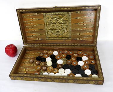 A Continental Inlaid Backgammon Set: A Continental Inlaid Backgammon Set intricately decorated and inlaid on all sides with mixed woods and mother of pearl insets. Original playing pieces inside plus what looks to be some additional piec