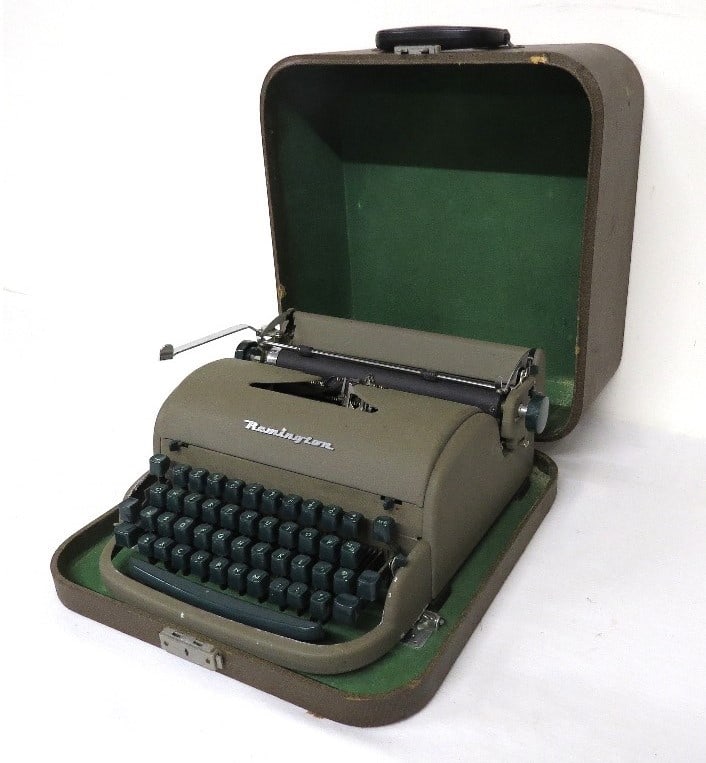 Early 1950's Remington Typewriter w/Green Bakelite Keys in Travel Case: An early 1950's Remington Typewriter with green keys in the original travel case. Very similar to the Quiet Riter but not labeled as such. Appears to be in good shape but has not been tested.