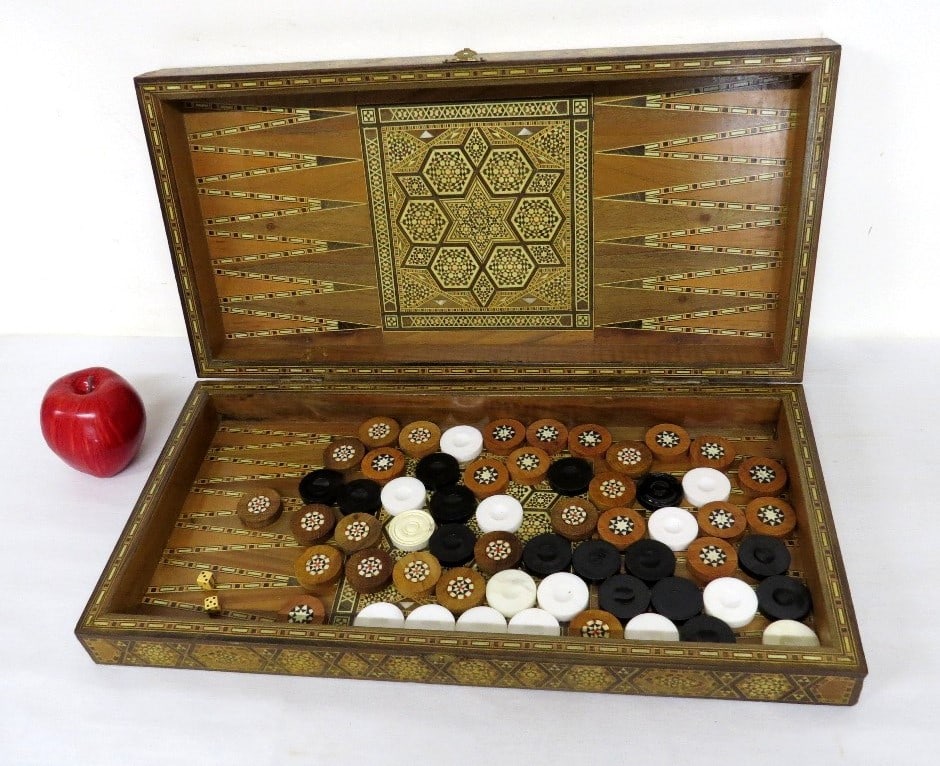 A Continental Inlaid Backgammon Set: A Continental Inlaid Backgammon Set intricately decorated and inlaid on all sides with mixed woods and mother of pearl insets. Original playing pieces inside plus what looks to be some additional piec