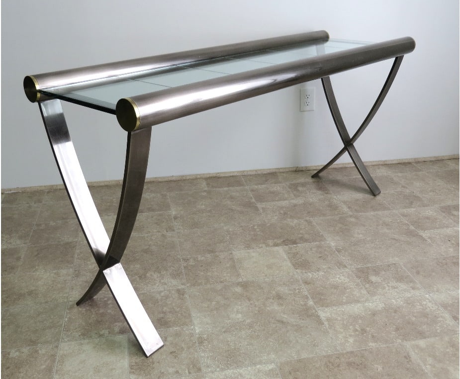 A Chrome, Brass & Glass Sculpted Console Table: A satin chromed finish with brass ends sculpted console table with glass insert top, measuring 61" in length, 28.5" height at glass top, 20" depth. Unsigned, vintage 1970's-80's look to it.