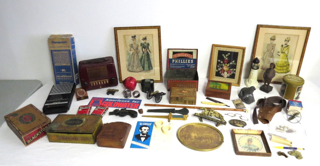 A Tabletop Assortment of 19th & 20th C. Collectibles: A rather diverse and extensive tabletop lot of collectibles of all kinds from red Bakelite radio, worlds fair, Mr. Peanut, a group of firearm tie tacks, toy brass cannons, framed oval carved trivet un