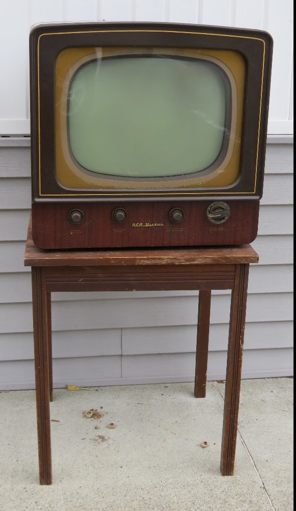 Vintage 1950's RCA Victor B&W Television on Original Swivel Table: 1950's RCA Victor Model 17T154 wood grained metal body television on original swivel top stand. TV will require restoration, no cord but appears to have its innards. If you have the skills it will mak