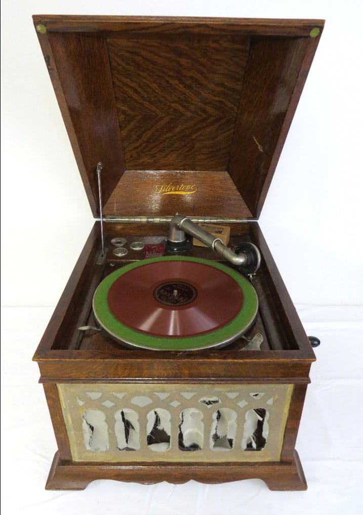 Antique Oak Tabletop Silvertone Phonograph Record Player w/Records: Antique oak cased Silvertone tabletop phonograph, previously restored, it does play but needs some adjustment to the slow/fast speed switch it rubs on the underside of the record table. The front gril