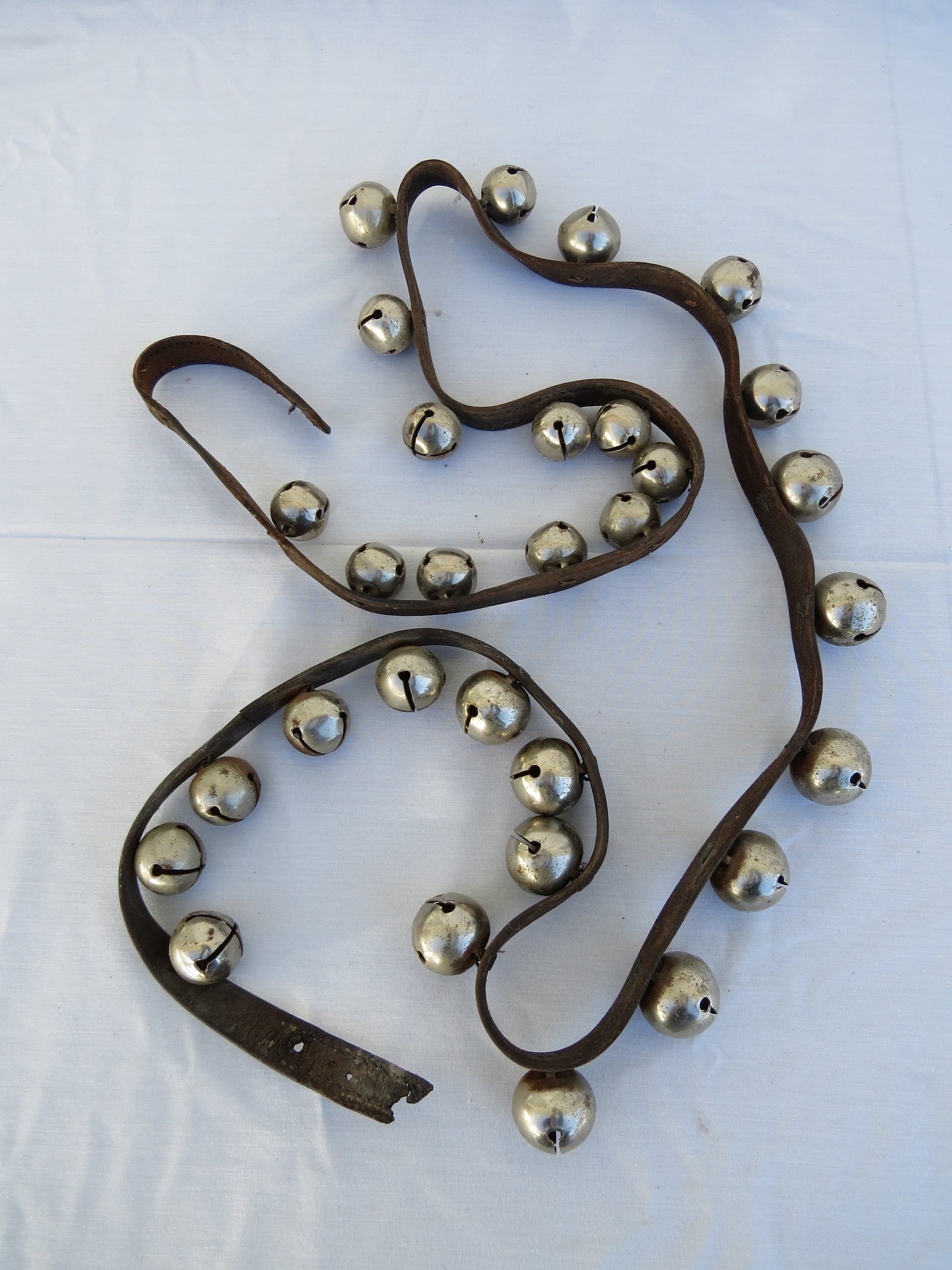 A 6 Foot String of Sleigh Bells on Leather: A string just about 72" in length of sleigh bells on leather. Note, this lot can be shipped in-house, you do not have to use the LiveShipping program.