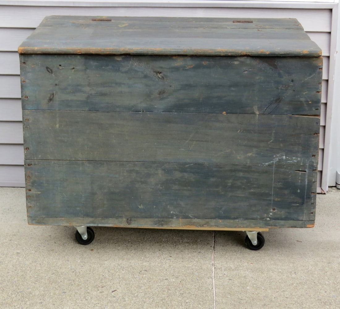 19th C. Large Sized Country Blanket Box / Firewood Box in Old Blue Paint: A 19th C. square nail constructed primitive box with hinged lid in old blue finish. Originally built in or against a corner or wall it retains the old leather strap handles, but is unpainted on the ri