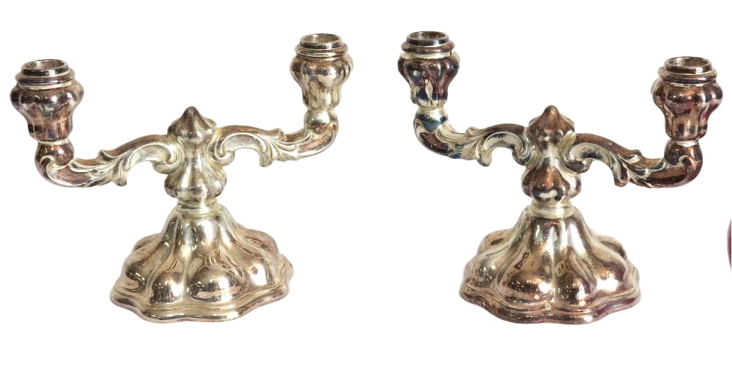 A Pair of 835 Silver European Double Candlesticks: A pair of mid-century 835 silver marked candlesticks, likely Germany/Bavaria. Each is 8.5" wide, 6.5" height. Bases appear to be weighted plates with .835 silver bodies. Some tarnishing.