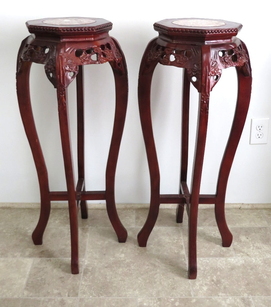 Two Asian Carved Rosewood Marble Topped Stands.: Two Asian carved stands with hexagon shaped tops with pink marble inserts. 36" in height, 11" diam.