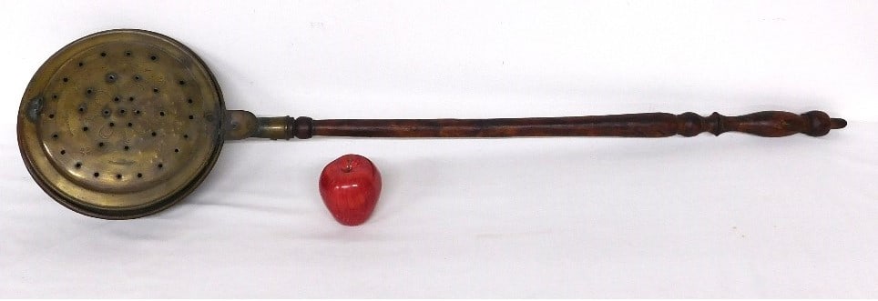 A 19th Century Pierced Brass Bed Warmer w/Mahogany: Another early 19th C. spun brass bed warmer with pierced lid for heat distribution of the coals, original turned mahogany finish handle measuring 45" long overall and a pan diameter of 10.5" in size.