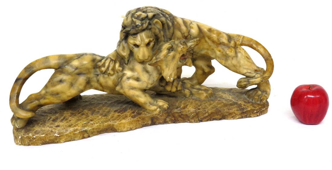 Carved Italian Alabaster Marble Sculpture of Lion's Fighting: An Italian Marbled Alabaster Sculpture of Fighting Lions with wonderful contrasting color marbling. Marked on base, 24" wide, 7" depth and 10.5" height. There is a repair to the tail on right side tha