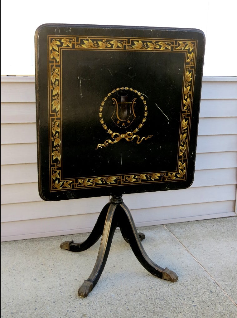 MCM English Regency Tilt Top Table With Gold Lyre Accents, Brass Feet: A mid-century English Regency styled tilt top table with gold accents on black surface, brass tipped feet. Some marks to top. Top is 26.75" by 26..75", height of 28"