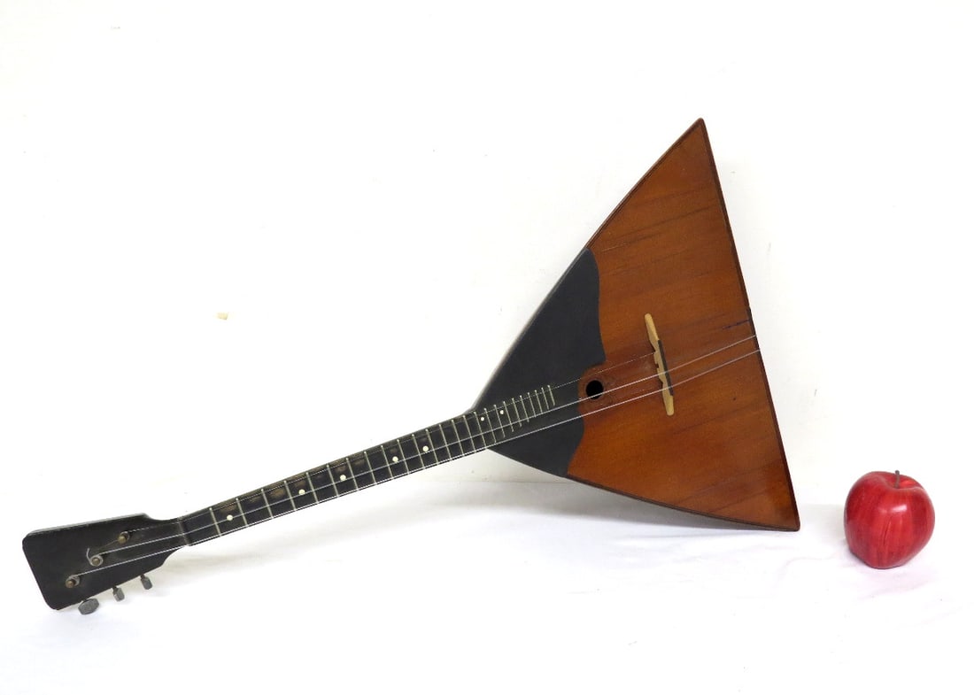 3 String Russian Balalika Musical Instrument.: A Russian balalaika 3 string banjo type instrument with characteristic triangular wooden hollow body, fretted neck, and three strings, 27.25" length, 16.25" width at widest point
