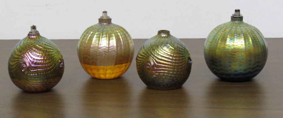 Tiffany Favrile Style Art Glass Lamps including John Gilvey: Group of 4 Tiffany Favrile style studio art glass oil lamps, two signed by John Gilvey c.2006. If shipping is required these will be emptied of their oils. One wick is missing.