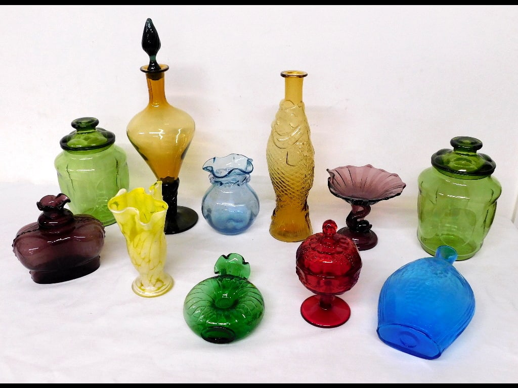 Table Lot of Mid-Century Glass: A table lot of mid-century glass in a variety of bright colors, the tall stoppered decanter has a chip at tip of stopper, all other pieces are good. Pieces by Clevenger, Antinori (Italy), Westmoreland