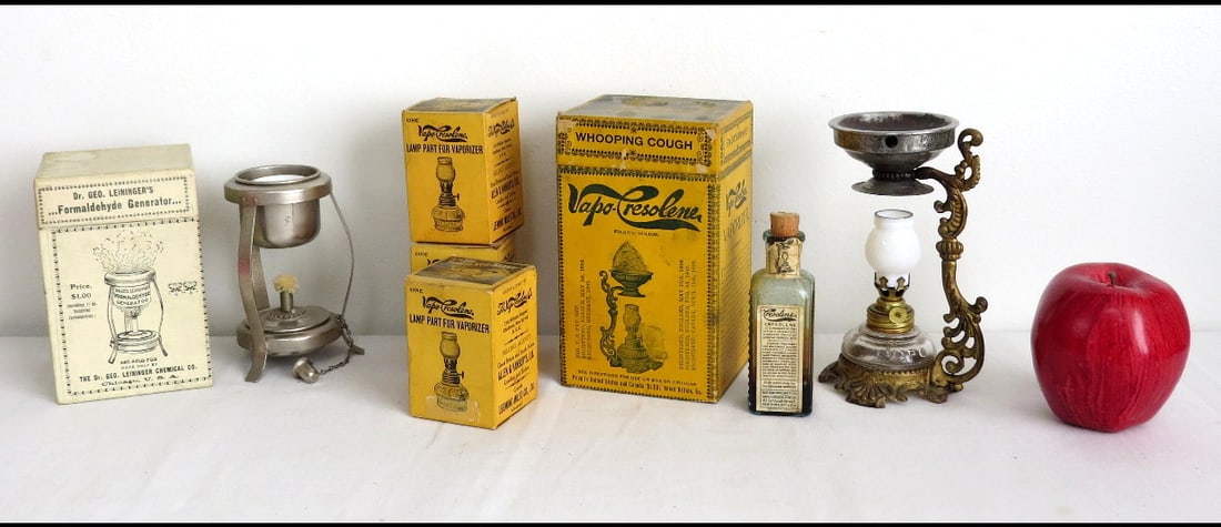Victorian Era Vapo-Cresoline Lamps and Accessories: A group of late Victorian Vapo-Cresoline and Leininger's Lamps, including 3 spare Vapo lamps in their boxes, a bottle of Vapo-Cresoline w/labels. The vapo-cresoline lamp is complete, including the bur