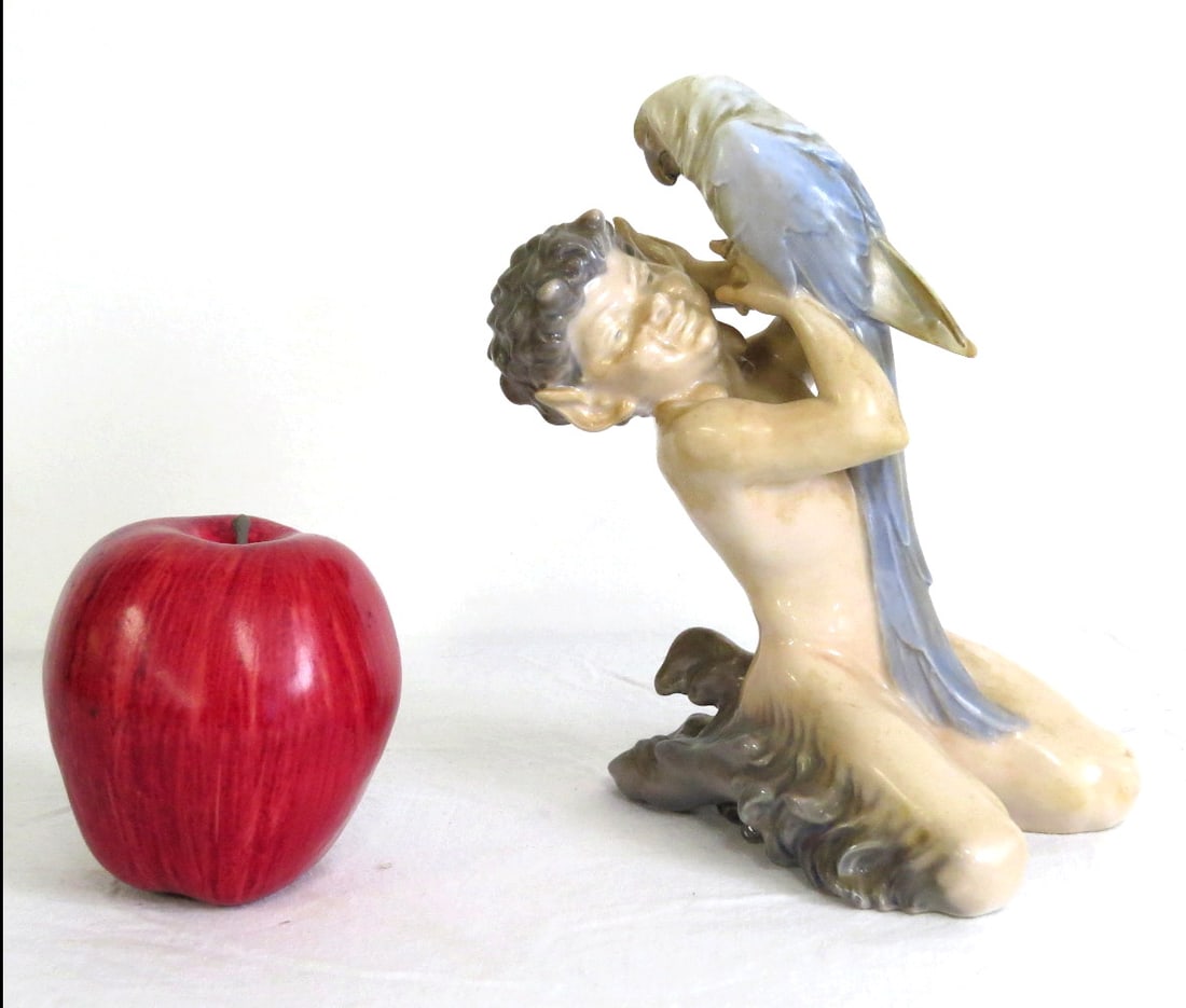 Royal Copenhagen Faun With Parrott No. 752 Porcelain Figure: Royal Copenhagen glazed porcelain figurine depicting a 'Faun With Parrot'. Model number #752. Marked with Royal Copenhagen hallmarks, height 6.25", no damage. This lot can be shipped in-house.