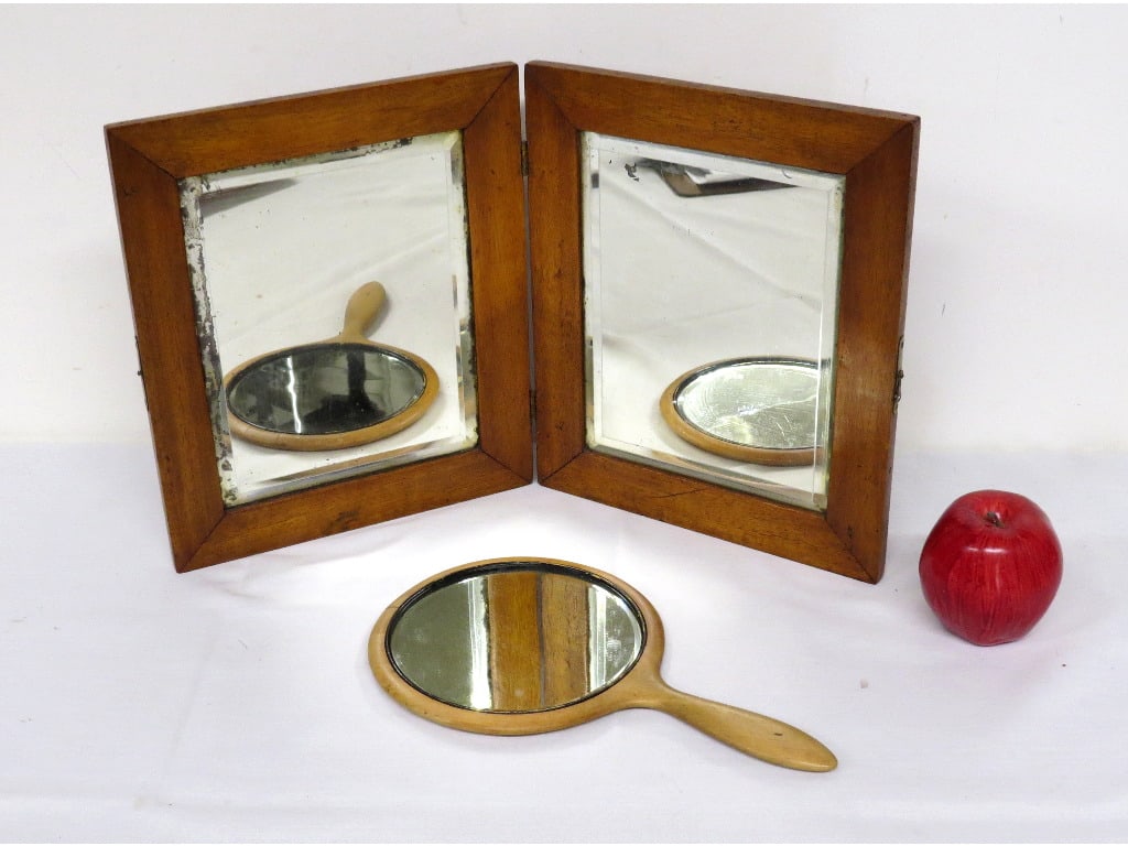 19th C. Star Inlaid Bi-Fold Table Mirror and Hand Mirror Beveled Glass: A 19th C. Oak framed bi-fold travel mirror with accompanying hand mirror. Bi-Fold has wonderful star marquetry inlay on both mirrors, original catch, measuring 11.5" height by 20" wide in size. Hand m