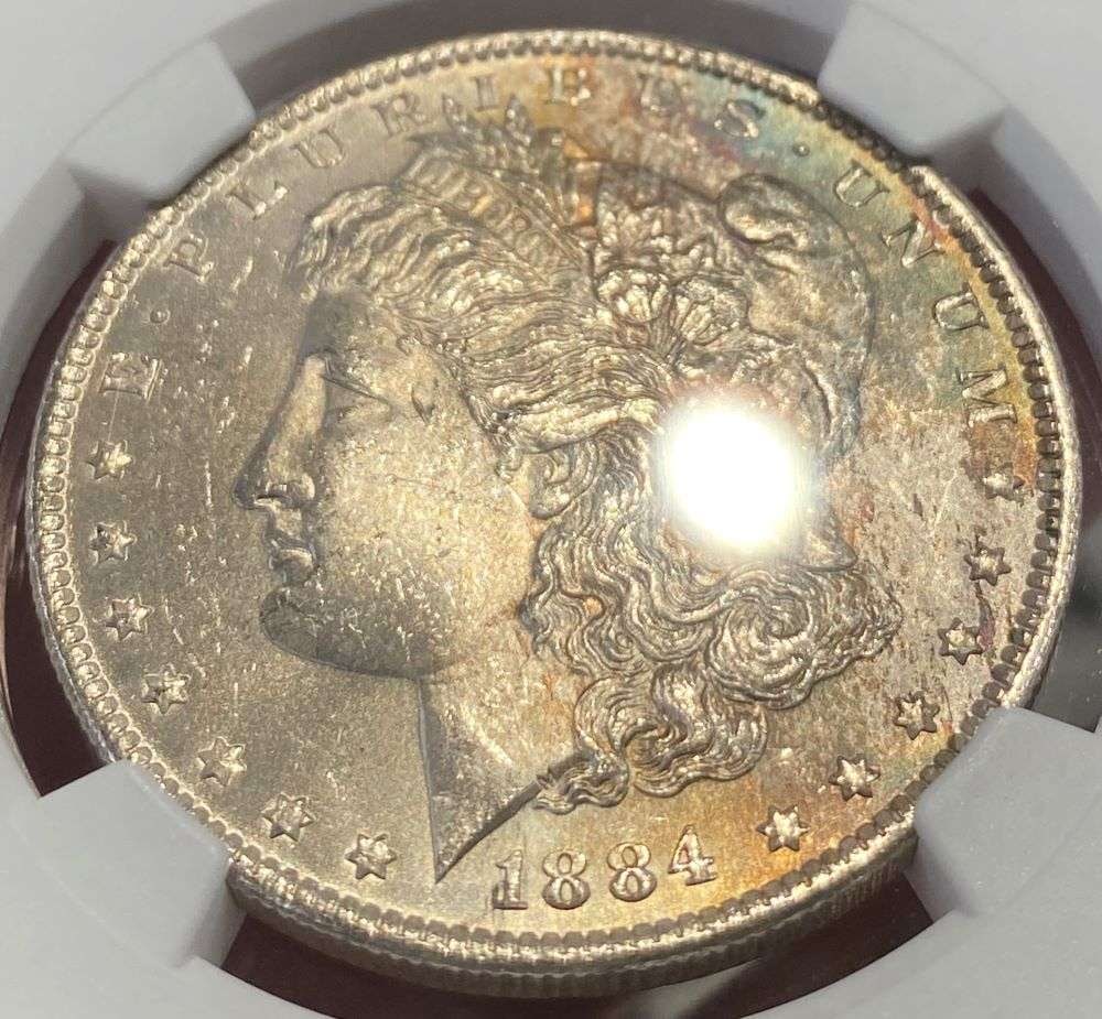 Toned 1884-O Morgan Silver Dollar NGC MS63: This coin comes from a very, very, very old collection that hasn't seen the light of day in decades. NGC has certified these as they originated from the 1961 treasury release of morgan silver dollars.
