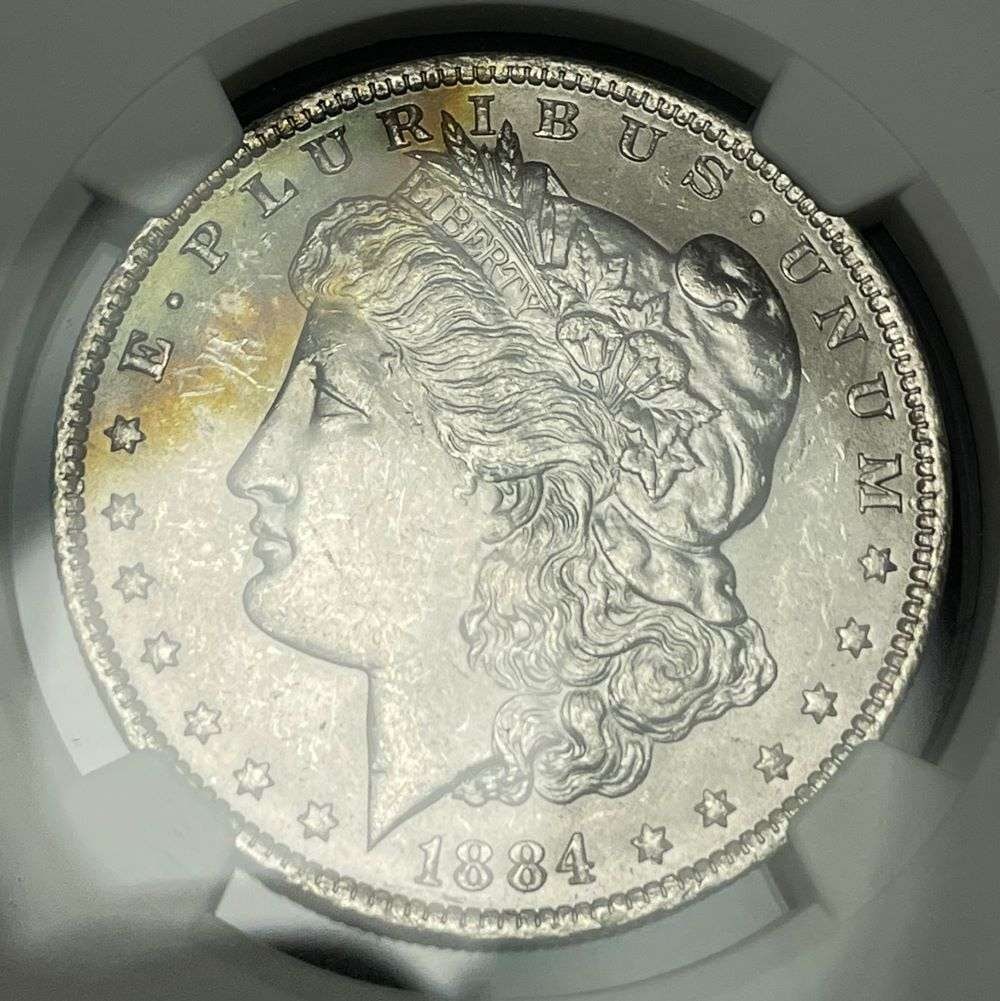 Toned 1884-O Morgan Silver Dollar NGC MS63: This coin comes from a very, very, very old collection that hasn't seen the light of day in decades. NGC has certified these as they originated from the 1961 treasury release of morgan silver dollars.