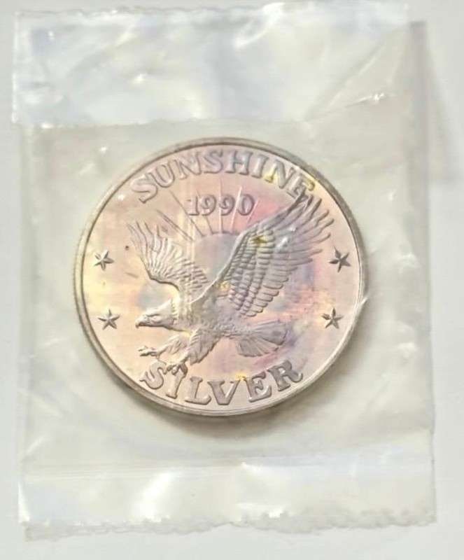 Toned 1990 Sunshine Mining 1 ozt .999 Silver: Mr. Larry recently came into our coin shop and sold us some of these beautiful 1 oz Sunshine silver rounds. Now retired, he once worked as a power line survey inspector for the Bonneville Power Admini