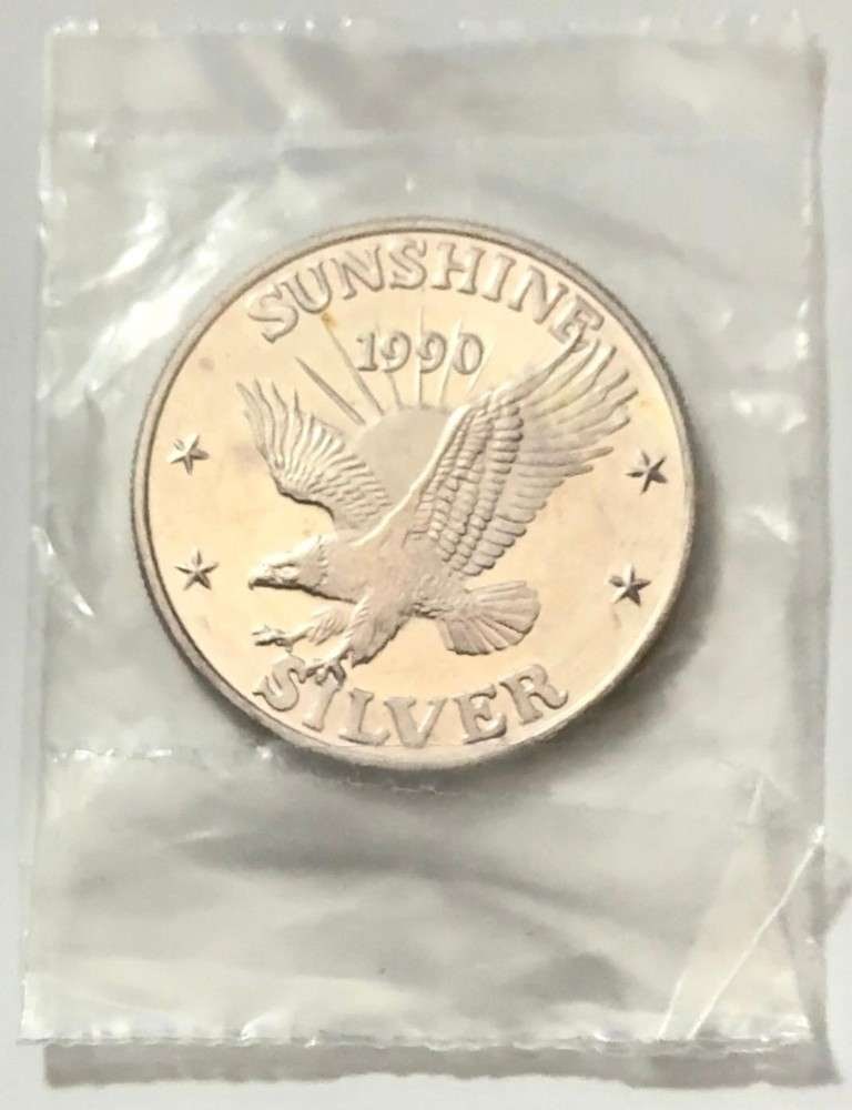 1990 Toned Sunshine Mining 1 ozt .999 Silver: Mr. Larry recently came into our coin shop and sold us some of these beautiful 1 oz Sunshine silver rounds. Now retired, he once worked as a power line survey inspector for the Bonneville Power Admini