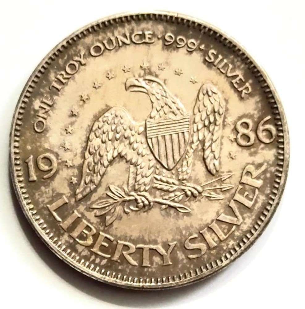 1986 Liberty Silver A-Mark 1 ozt .999 Silver: Winner shall receive the exact round shown here. (SJ/B)