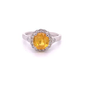 Yellow Sapphire Platinum Ring: This lovely sapphire ring features a 2.61 ct oval cut yellow sapphire is surrounded by .24cts of diamonds. This ring is made in 6.1g of platinum. This ring is modern and sleek.