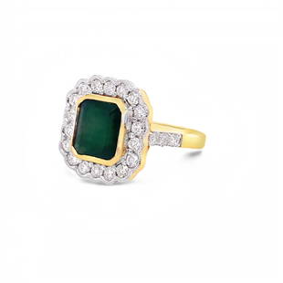 18kt Yellow Gold Emerald and Diamond Ring: This vintage style Emerald Ring is set with an emerald center stone weighing 3.00 ct, surrounded by a halo of .96 cts of diamonds set in 18kt yellow gold.