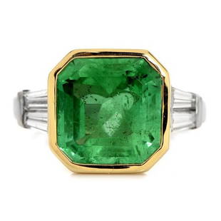 Estate Diamond 5.60ct Colombian AGL Emerald 18K Gold Engagement Ring: Prominent in the center is an Octagonal Shaped Natural Colombian Emerald, weighing appx. 5.60 carats, AGL Certified with Minor enhancement(OIL ONLY). Flanking either side are (4) Tapered Baguette cut,