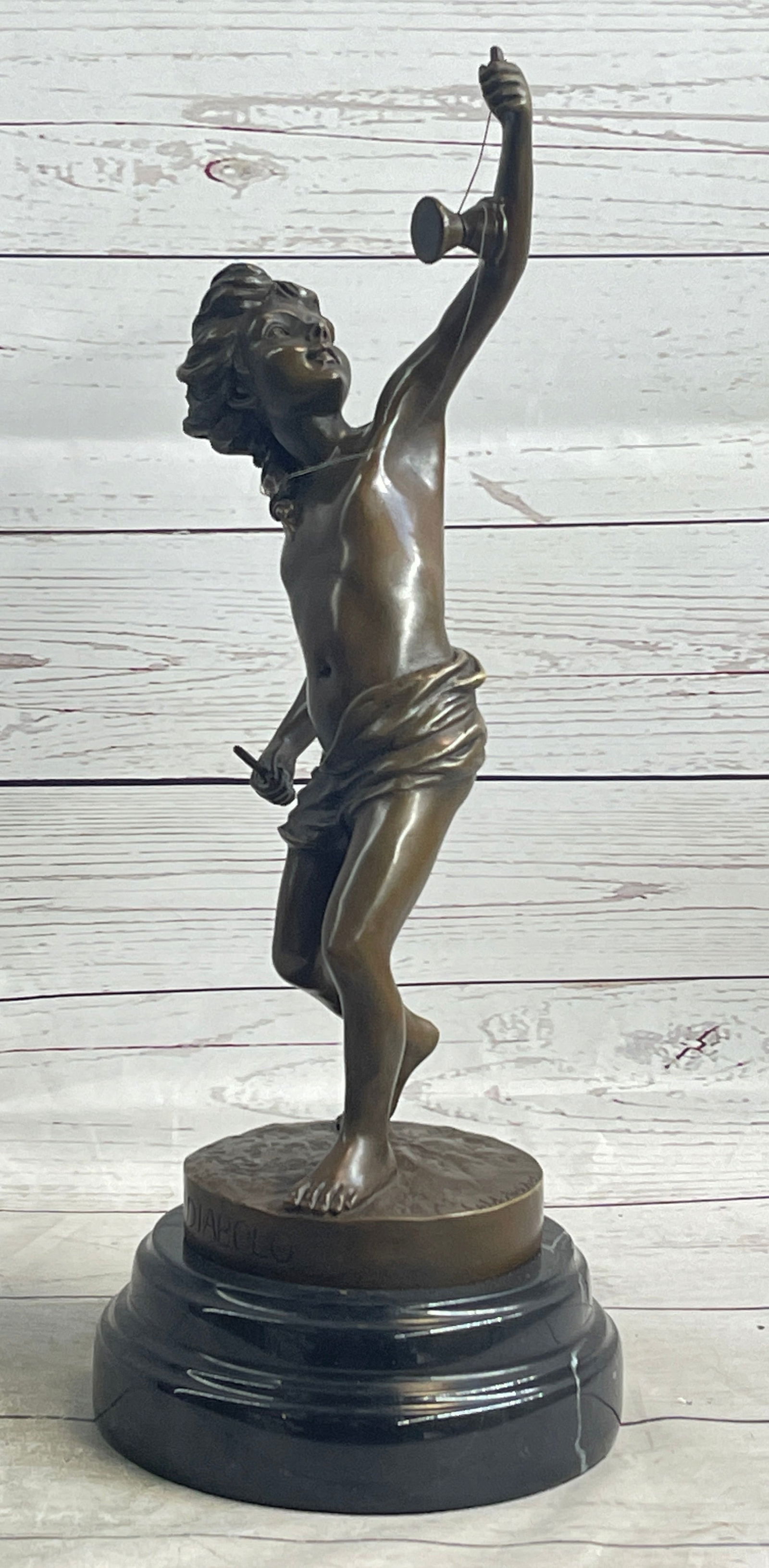 Diabolo Signed Goldscheider Young Boy With Sling Bronze Sculpture Statue: Bronze Dimensions with Marble Base: Height 16 X Width 9.5Marble Dimensions: Diameter 6Height without base:14Weight:12 LBSOriginal or Reproduction: Reproduction