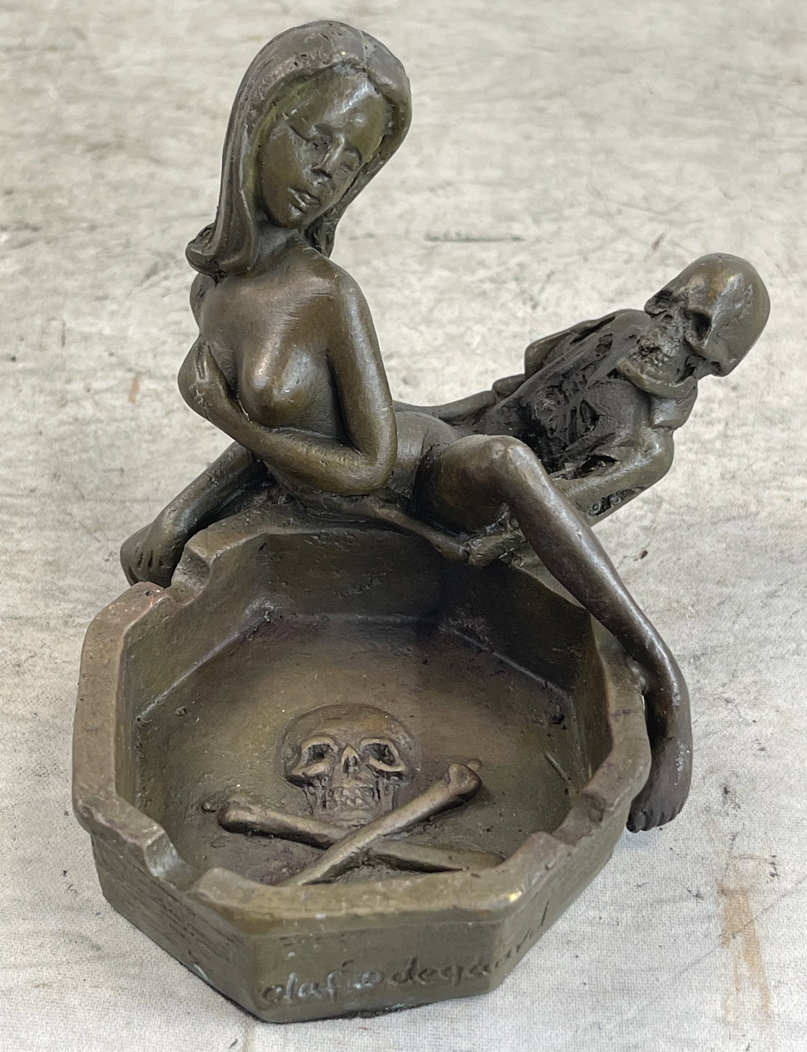 Odegaard Skeleton with Nude Girl Ashtray Bronze: Total Dimensions: Height 3'' x Width 5''Approximate Weight: 2 LBSOriginal Reproduction: Original