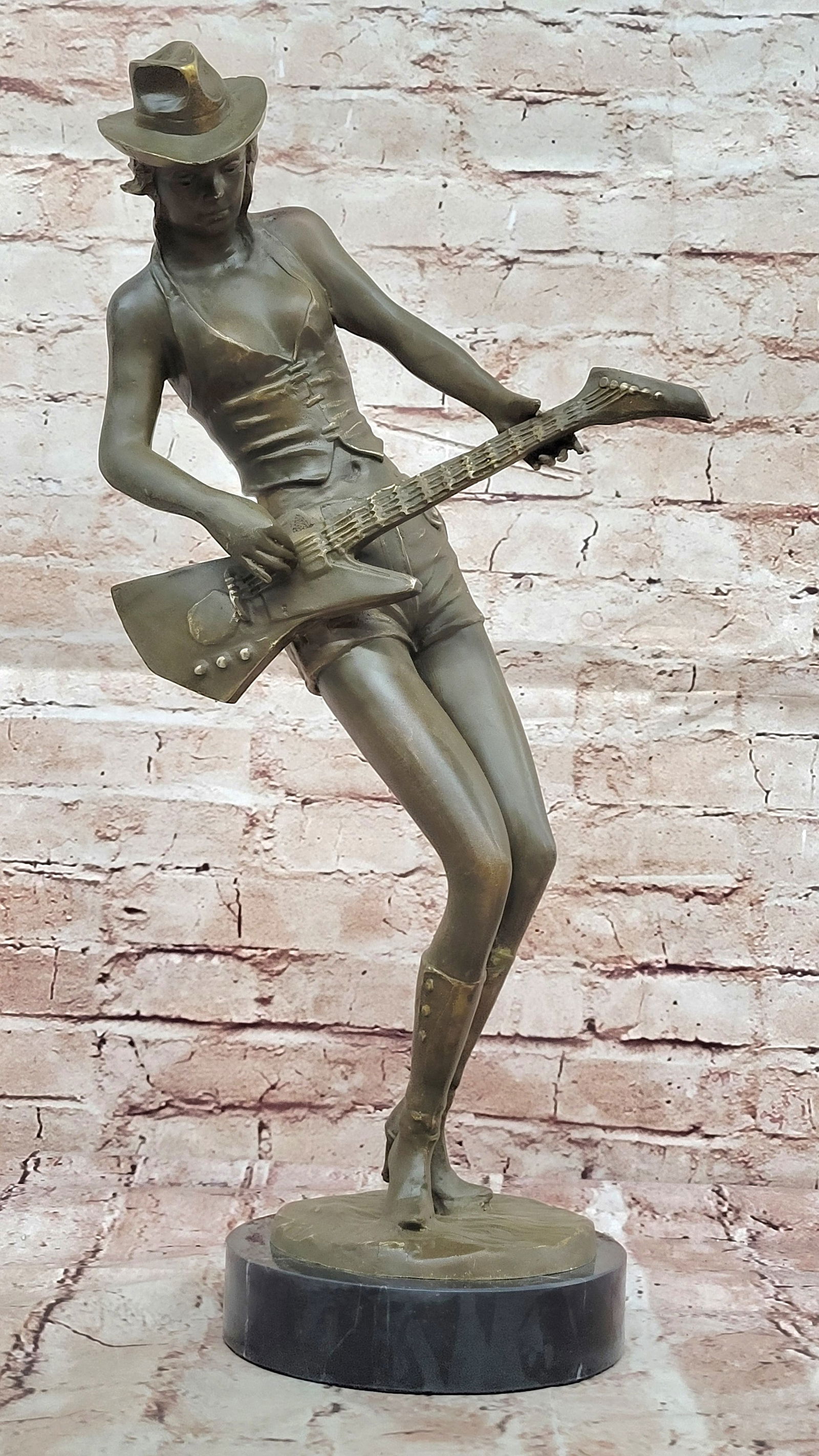 Rock and Roll Girl Guitarist Bronze Sculpture on Base: Bronze Dimensions with Marble Base: Height 19" X Width 9.5"Marble Dimensions: Diameter 6"Height without base:18"Weight:12 LBSOriginal or Reproduction: Original